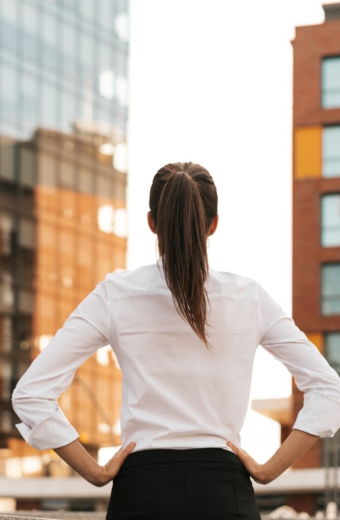 Rear view of businesswoman looking business buildings